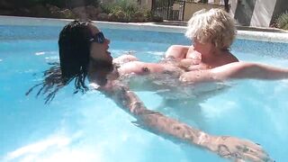 Camilla and Cheyenne Play with a double ended sex toy in the pool