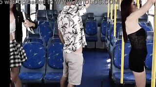 Stranger sneaks up behind female college students on the bus!