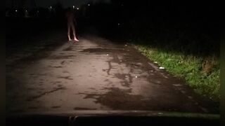 Risky in nature's garb on road with car passing
