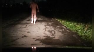 Risky in nature's garb on road with car passing