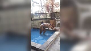 Married redhead showing off in the condo pool to a neighbour.