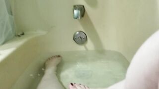 Washing my charming little feet in the bathtub.