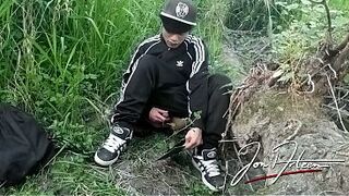 Cute Oriental homosexual twink in a ebony-and-white adidas tracksuit and Campus sneakers masturbates and cums outdoors