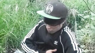 Cute Oriental homosexual twink in a ebony-and-white adidas tracksuit and Campus sneakers masturbates and cums outdoors