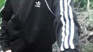 Cute Oriental homosexual twink in a ebony-and-white adidas tracksuit and Campus sneakers masturbates and cums outdoors