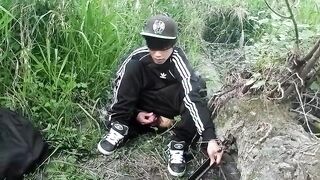Cute Oriental homosexual twink in a ebony-and-white adidas tracksuit and Campus sneakers masturbates and cums outdoors