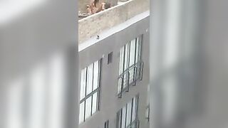 Lesbian strap-on on rooftop