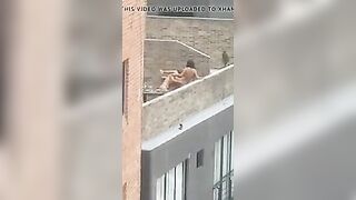 Lesbian strap-on on rooftop
