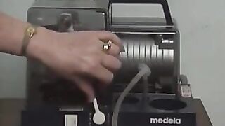 Old woman milks the saggy tit of a young woman