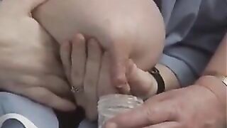 Old woman milks the saggy tit of a young woman