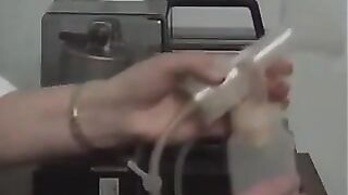 Old woman milks the saggy tit of a young woman