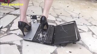 Hot woman destroys two laptops with her high heels and with a hammer
