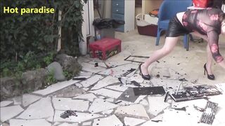 Hot woman destroys two laptops with her high heels and with a hammer