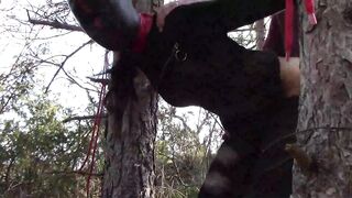 Bound up to a tree outdoor on hawt garments, wearing hose and high ankle boots heels, coarse screw
