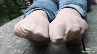 Jeans Feet In Nylon Socks In The Forest