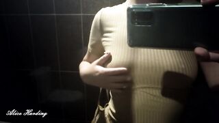 Alice in a beige dress sits in a bar walking down the street and posing near the mirror showing breasts