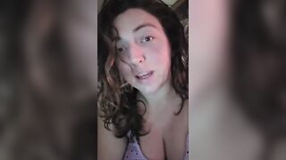 big beautiful woman lets her large breasts hang whilst water oozes down from 'em