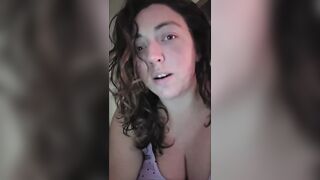 big beautiful woman lets her large breasts hang whilst water oozes down from 'em