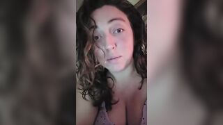 big beautiful woman lets her large breasts hang whilst water oozes down from 'em