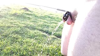 Desperately peeing in chastity cage by lake