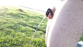 Desperately peeing in chastity cage by lake