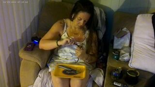 Breasty beauty in pink brassiere and pants smokin' and playing movie games
