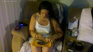 Breasty beauty in pink brassiere and pants smokin' and playing movie games
