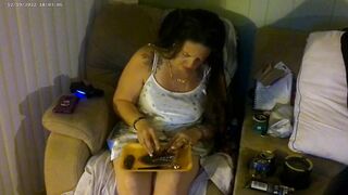Breasty beauty in pink brassiere and pants smokin' and playing movie games