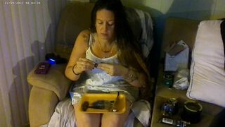 Breasty beauty in pink brassiere and pants smokin' and playing movie games