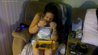 Breasty beauty in pink brassiere and pants smokin' and playing movie games