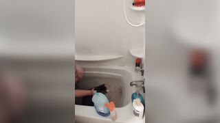 Charming gal gives kitten a washroom