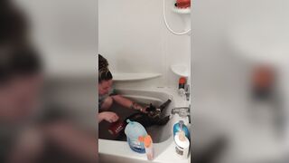 Charming gal gives kitten a washroom