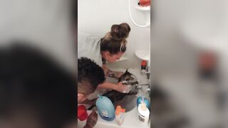 Charming gal gives kitten a washroom