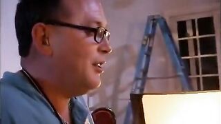 Behind the scenes footage of a camera crew filming a porn video