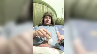A man lies down, jerks off, cums, eats cum, and plays with a lighter.