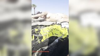 Stripped gal playing in the sand?