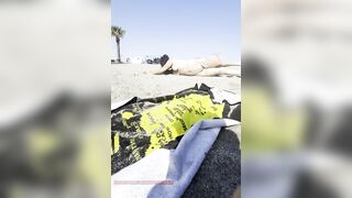Stripped gal playing in the sand?