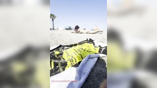 Stripped gal playing in the sand?