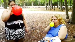 two bbws are balloon blowing and popping
