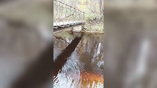 Latvian beauty jumps off a bridge into the river.