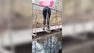 Latvian beauty jumps off a bridge into the river.