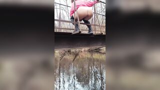 Latvian beauty jumps off a bridge into the river.