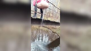 Latvian beauty jumps off a bridge into the river.
