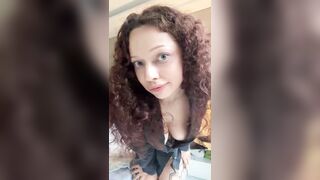 Hairy-haired cutie leans forward, cleavage on display ?
