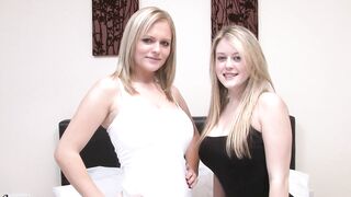 Lesbian couple rub their breasts together on the bed