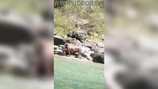 Floozy having sex on the beach with a stranger.