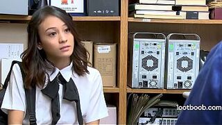 Small Oriental shoplifter screws security guard on the stockroom desk