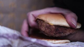 close up - screwing a cheeseburger