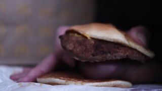 close up - screwing a cheeseburger