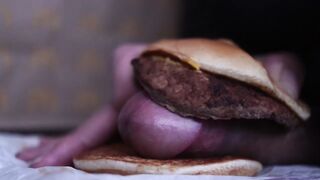 close up - screwing a cheeseburger